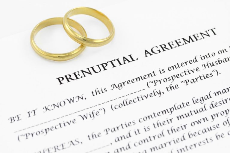 Prenuptial agreement contract with a pair of rings