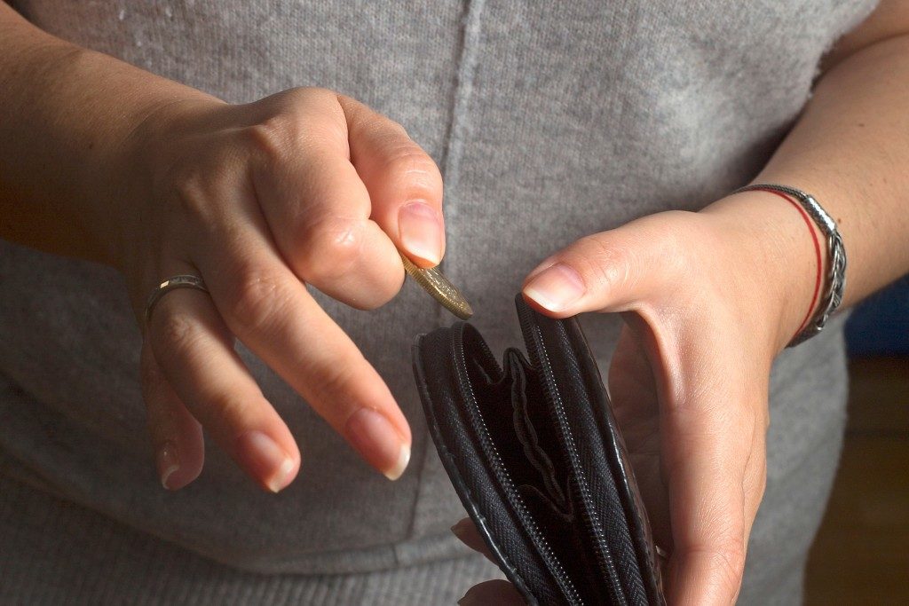 Woman putting card in the wallet