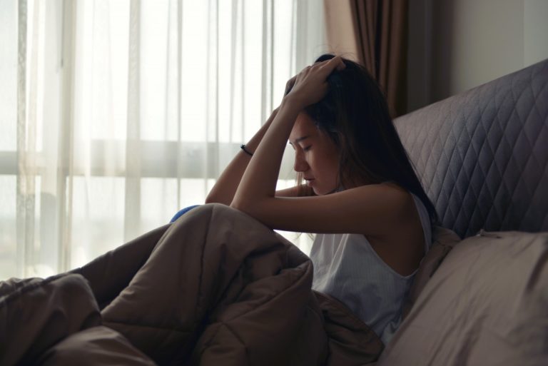 Woman crying in bed