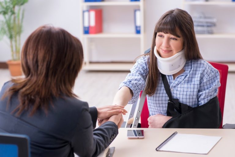 injured woman consulting a lawyer