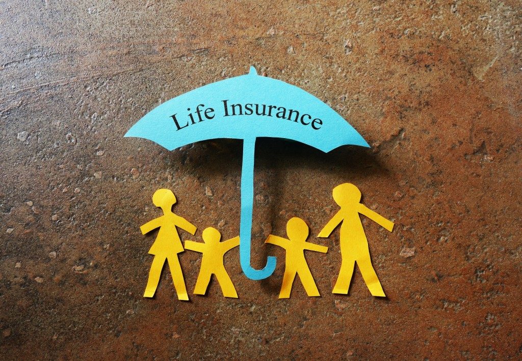 family cutout under a life insurance umbrella