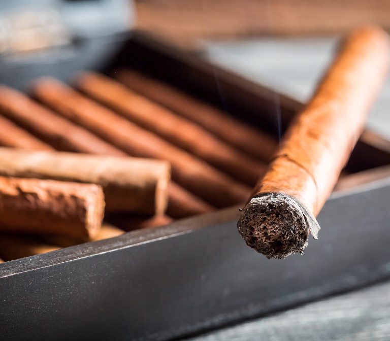 Closeup of burning cigar with smoke