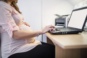 pregnant woman working on a laptop